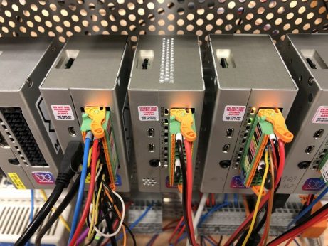 A group of Raspberry Pi 4 and Monarco HAT-based PLCs on a DIN-rail